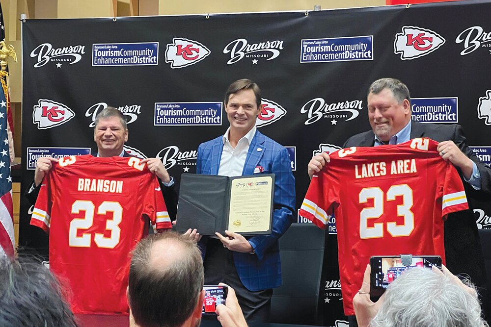 PARTNERSHIP PROMOTION: From left, Branson Mayor Larry Milton, Kansas City Chiefs President Mark Donovan and Derek Smith, then-board chair of the Branson/Lakes Area Tourism Community Enhancement district, celebrate the signing of a partnership agreement at an August 2023 ceremony.